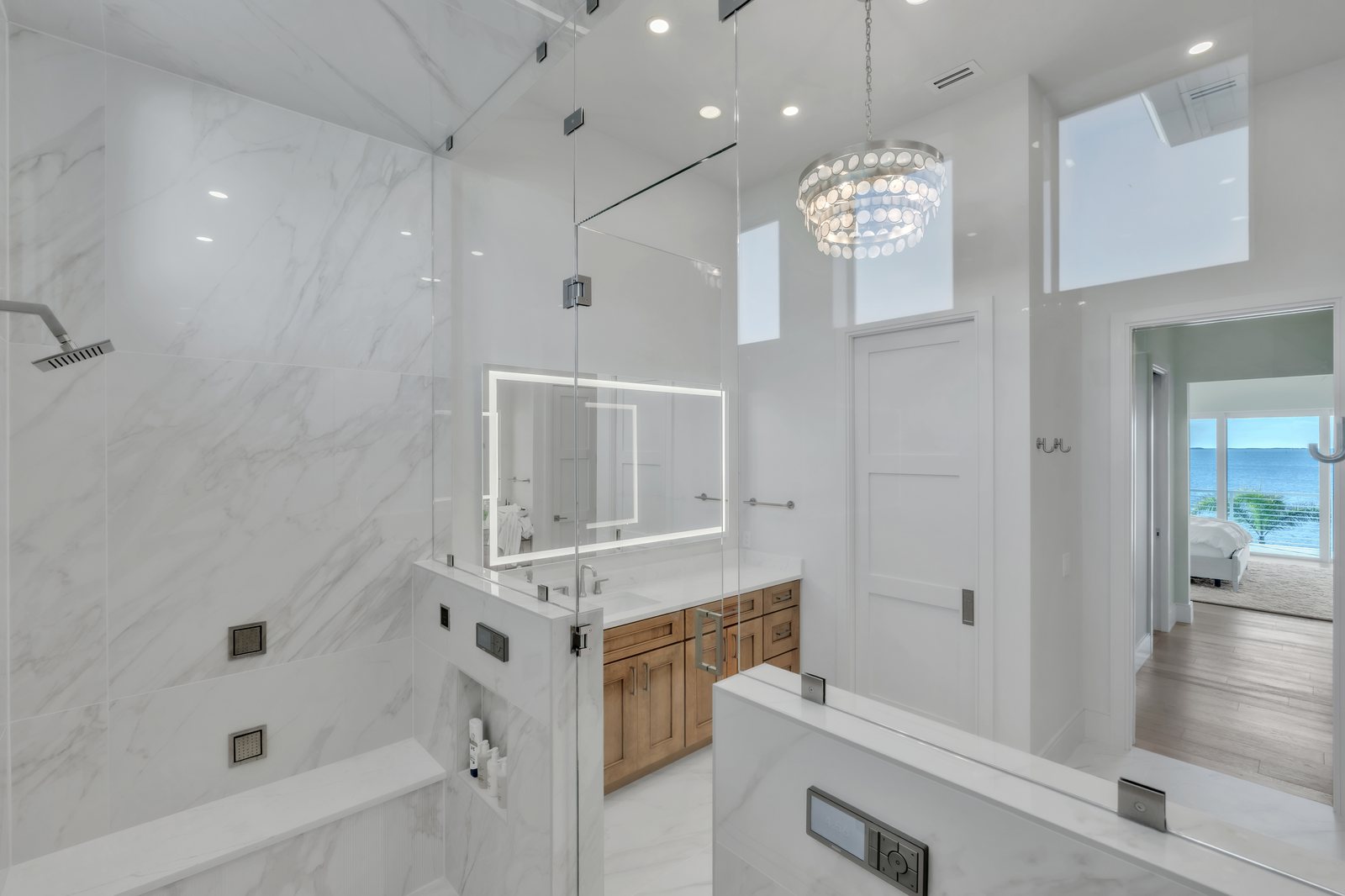 Marble master bath and shower overlooking the water