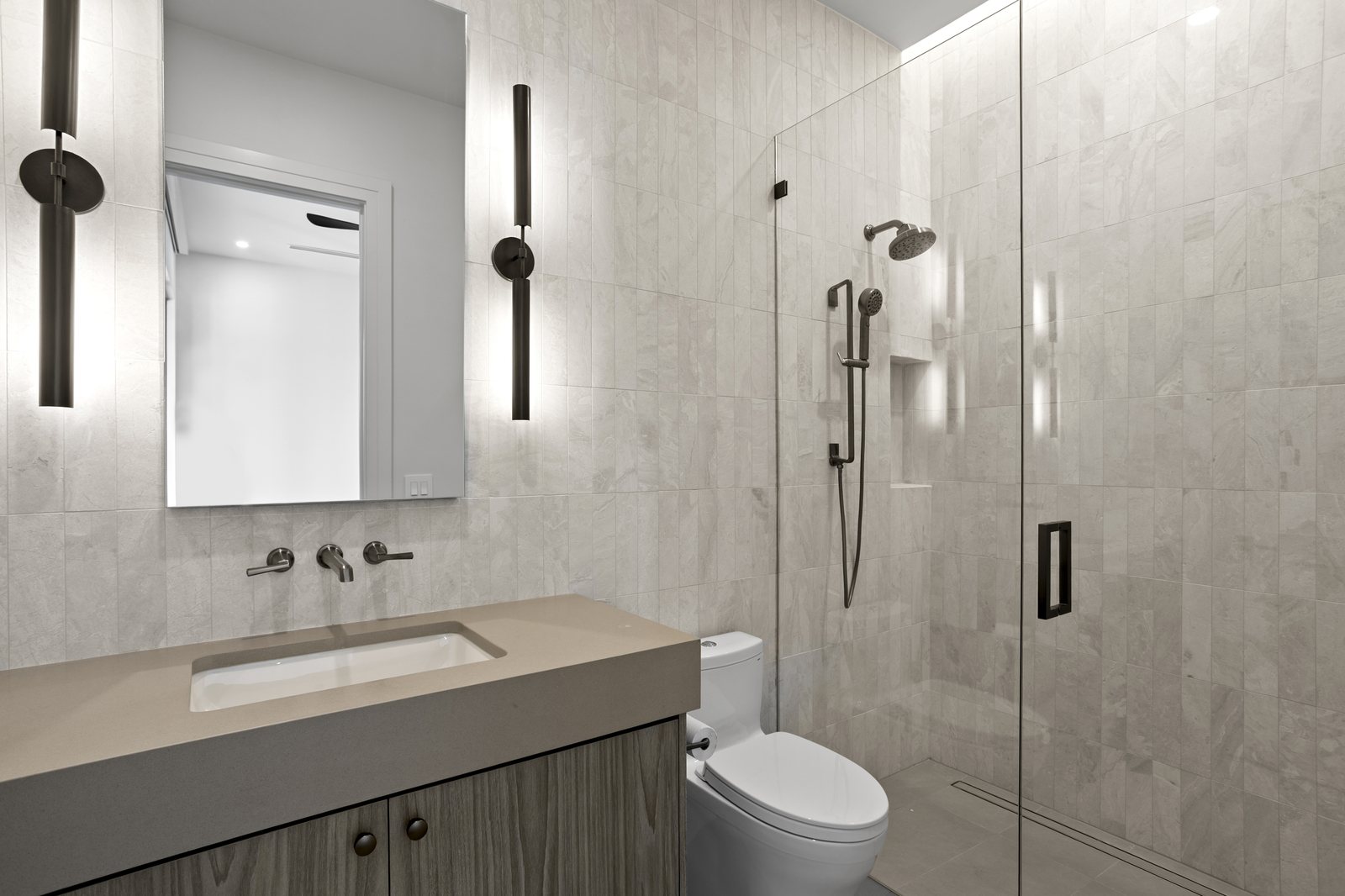Modern bath with wall-mounted faucet and walk-in shower